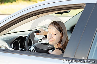 Teenager in car,student driver in a driving school at a driving lesson behind the wheel of a car,girl gets a driver`s license Stock Photo