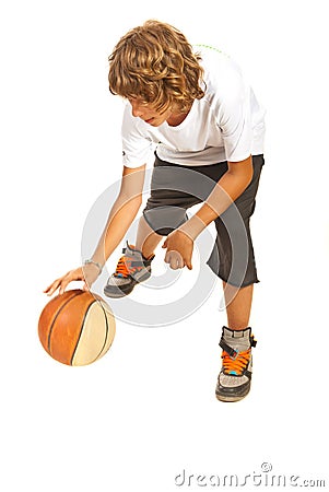 Teenager dribbling basketball Stock Photo