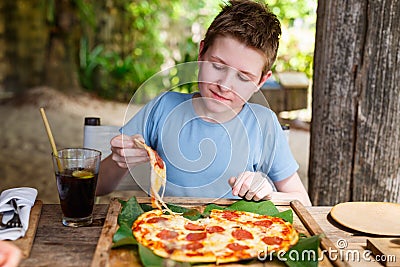 Teenager eating pizza Stock Photo