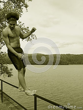 Teenager Falling Backward by a lake Stock Photo