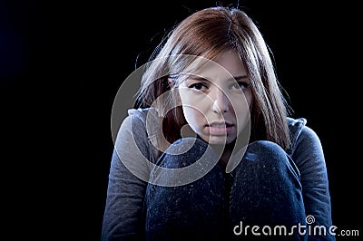 Teenager girl feeling lonely scared sad and desperate suffering depression bullying victim Stock Photo