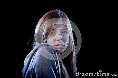 Teenager girl feeling lonely scared sad and desperate suffering depression bullying victim Stock Photo