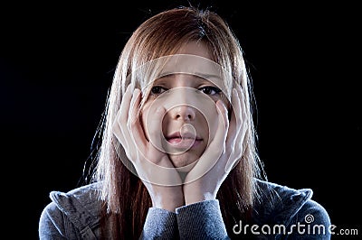 Teenager girl feeling lonely scared sad and desperate suffering depression bullying victim Stock Photo