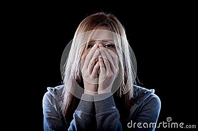 Teenager girl feeling lonely scared sad and desperate suffering depression bullying victim Stock Photo