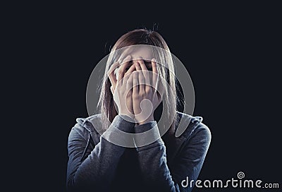 Teenager girl feeling lonely scared sad and desperate suffering depression bullying victim Stock Photo