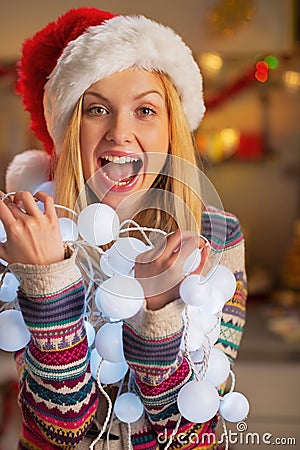 Teenager girl holding tangled christmas lights Stock Photo