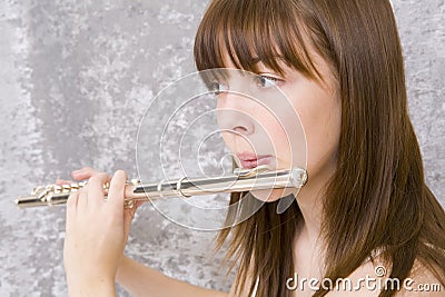 Teenager girl playing flute Stock Photo