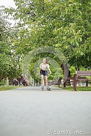 Teenager girl quickly roller skates in skate park. Active lifestyle, hobby and childhood concept Stock Photo