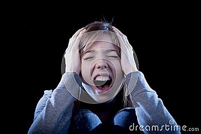 Teenager girl with red hair feeling lonely screaming desperate as bullying victim in depression Stock Photo