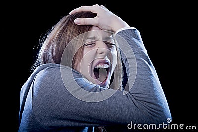 Teenager girl with red hair feeling lonely screaming desperate as bullying victim in depression Stock Photo