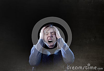 Teenager girl with red hair feeling lonely screaming desperate a Stock Photo