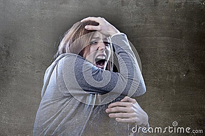 Teenager girl with red hair feeling lonely screaming desperate a Stock Photo