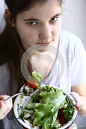 Teenager girl vegan with salad bowl close up photo Stock Photo