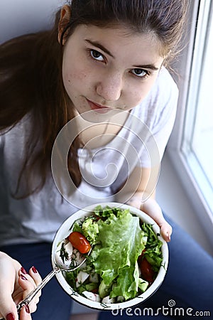 Teenager girl vegan with salad bowl close up photo Stock Photo