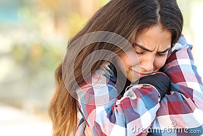 Teenager girl worried and sad outdoors Stock Photo