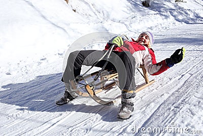 Teenager have fun with sledge Stock Photo