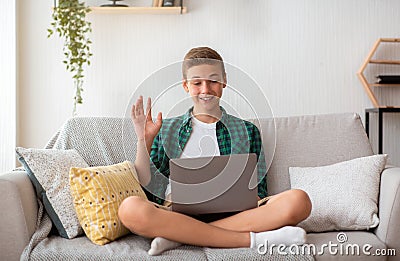 Teenager having videochat on laptop from home Stock Photo