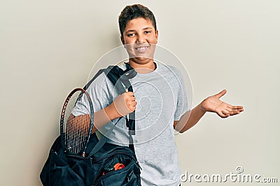 Teenager hispanic boy holding sport bag celebrating achievement with happy smile and winner expression with raised hand Stock Photo