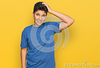 Teenager hispanic boy wearing casual clothes confuse and wonder about question Stock Photo