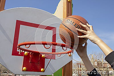 Basketball shot in street game, hands holding ball Editorial Stock Photo