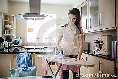 Teenager Ironing Laundry Stock Photo