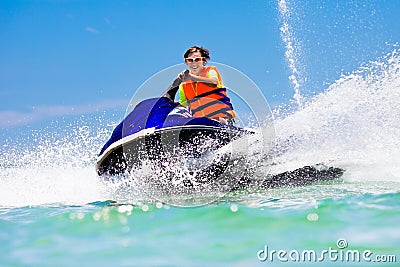 Teenager on jet ski. Teen age boy water skiing. Stock Photo