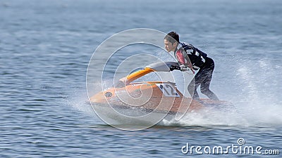 Teenager on Jet Ski-Water Sports in the summer having fun on the beach Editorial Stock Photo