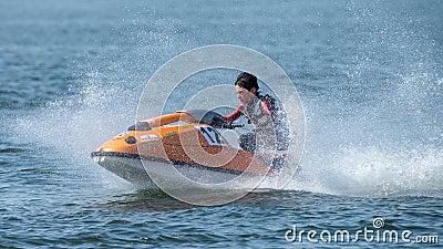 Teenager on Jet Ski-Water Sports in the summer having fun on the beach Editorial Stock Photo