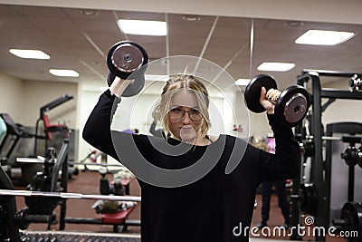 Teenager lifting dumbbells Stock Photo