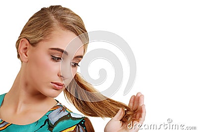 Teenager looking at her hair Stock Photo