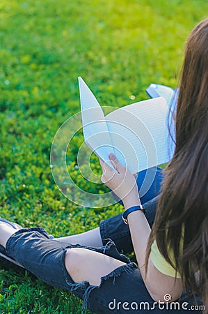 Teenager looking at notebook. Studying outdoors Stock Photo