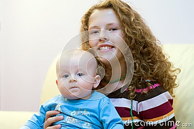 Teenager with newborn brother Stock Photo