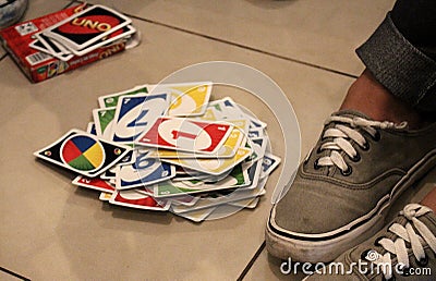 Teenager playing cards on the floor. Having some fun Editorial Stock Photo