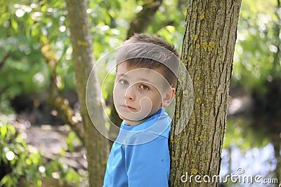 A teenager poses for a photographer while walking in the park. Stock Photo