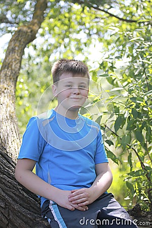 A teenager poses for a photographer while walking in the park. Stock Photo