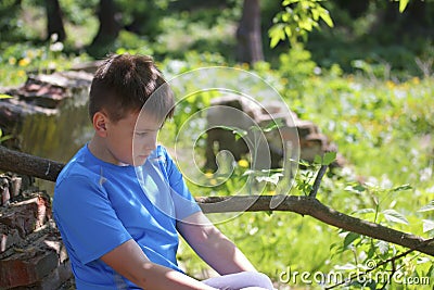 A teenager poses for a photographer while walking in the park. Stock Photo