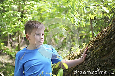 A teenager poses for a photographer while walking in the park. Stock Photo