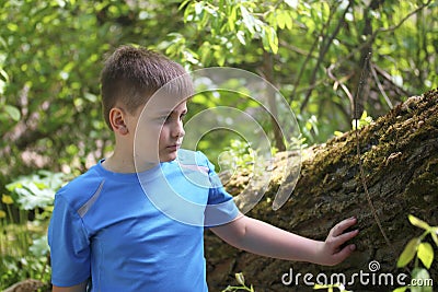 A teenager poses for a photographer while walking in the park. Stock Photo