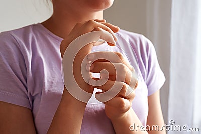 Teenager practicing EFT - emotional freedom technique - tapping on the karate chop point Stock Photo