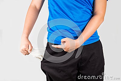 Teenager pulling out and pointing his empty pockets Stock Photo