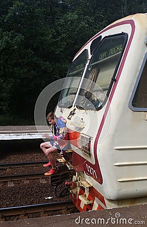 A teenager rides a train. Editorial Stock Photo