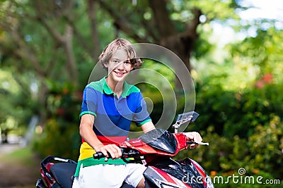 Teenager riding scooter. Boy on motorcycle. Stock Photo