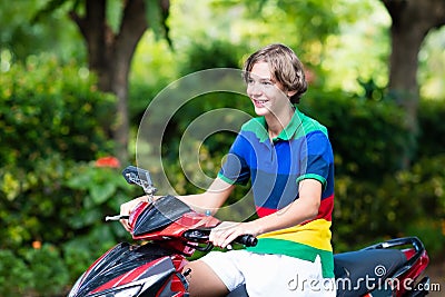 Teenager riding scooter. Boy on motorcycle. Stock Photo