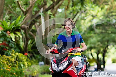 Teenager riding scooter. Boy on motorcycle. Stock Photo