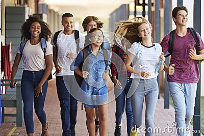 Teenager school kids running in high school hallway Stock Photo