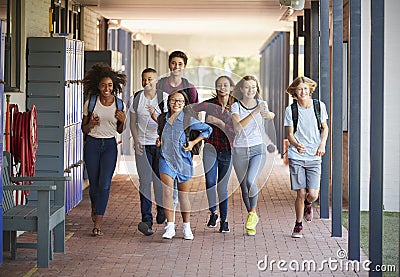 Teenager school kids running in high school hallway Stock Photo