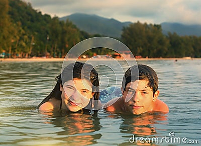 Teenager siblings couple brother and sister swimming in the sea Stock Photo