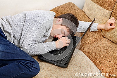 Teenager sleeps on Laptop Stock Photo