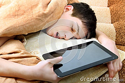 Teenager sleeps with Tablet Stock Photo