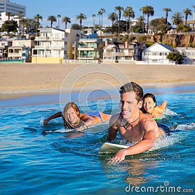 Teenager surfer boys and girls swimming ove surfboard Stock Photo